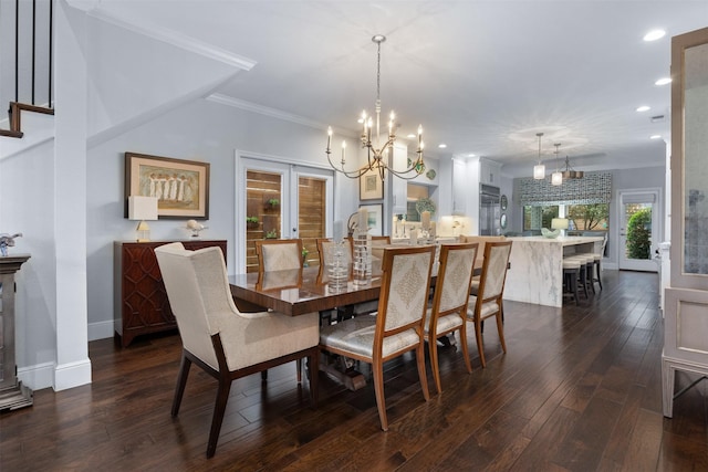 dining room featuring french doors, dark wood-type flooring, a chandelier, and ornamental molding