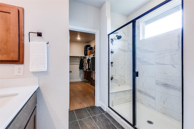 bathroom featuring vanity and a shower with shower door