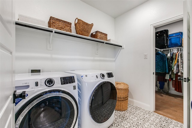 laundry room featuring washing machine and clothes dryer