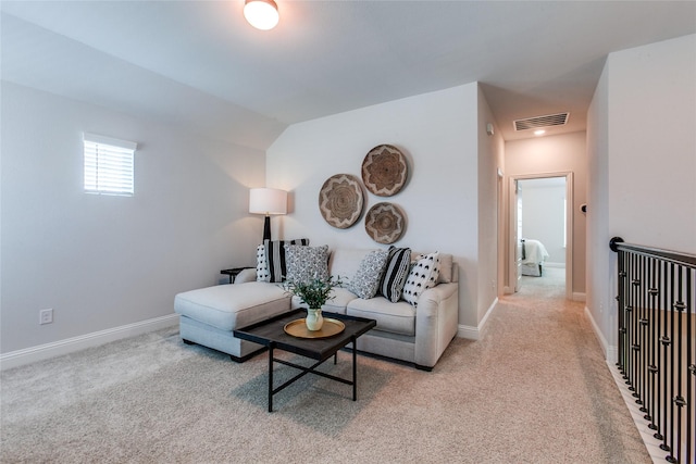 carpeted living room with lofted ceiling