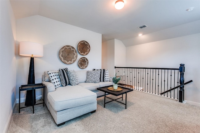 carpeted living room with vaulted ceiling