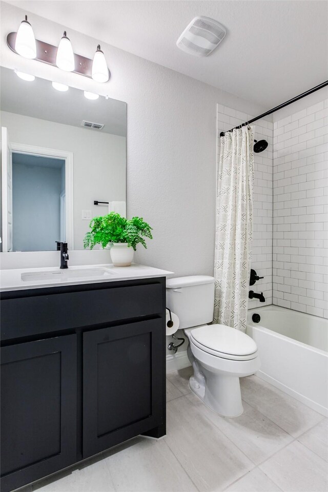 full bathroom featuring tile patterned flooring, vanity, toilet, and shower / tub combo