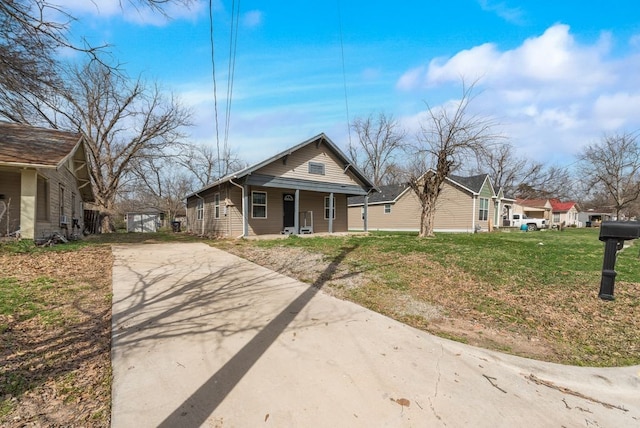 bungalow featuring a porch and a front yard