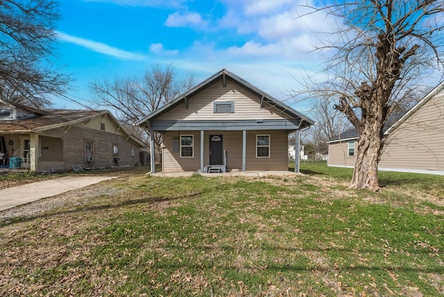 bungalow-style house featuring a porch and a front yard