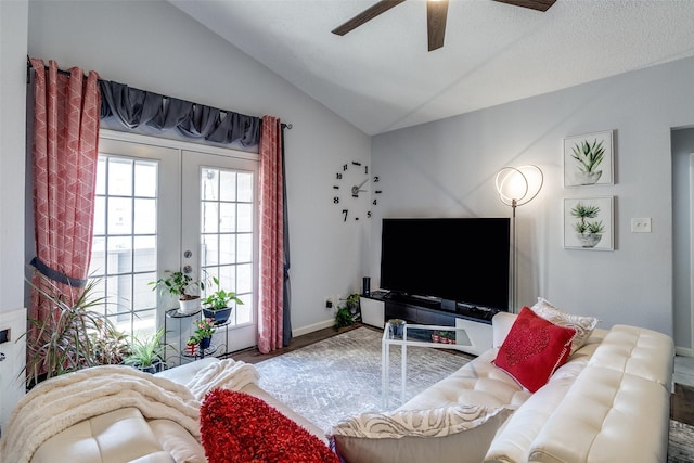 living area featuring french doors, lofted ceiling, ceiling fan, wood finished floors, and baseboards