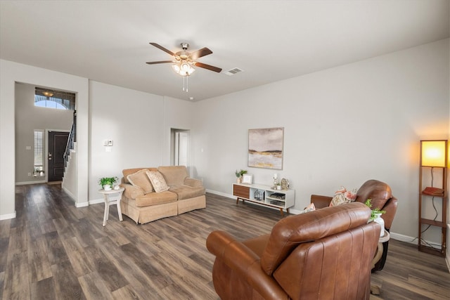 living room with baseboards, visible vents, stairway, and wood finished floors