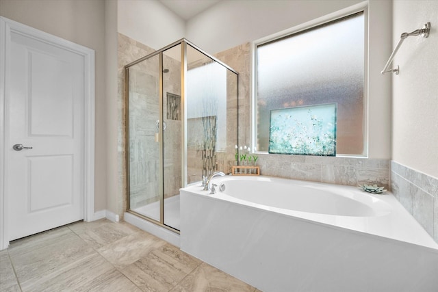 bathroom featuring a stall shower and a garden tub