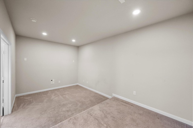 unfurnished room with light carpet, baseboards, and recessed lighting