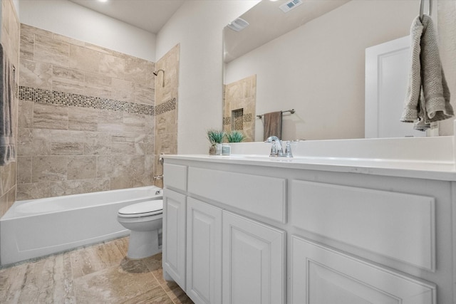 bathroom featuring visible vents, shower / washtub combination, vanity, and toilet