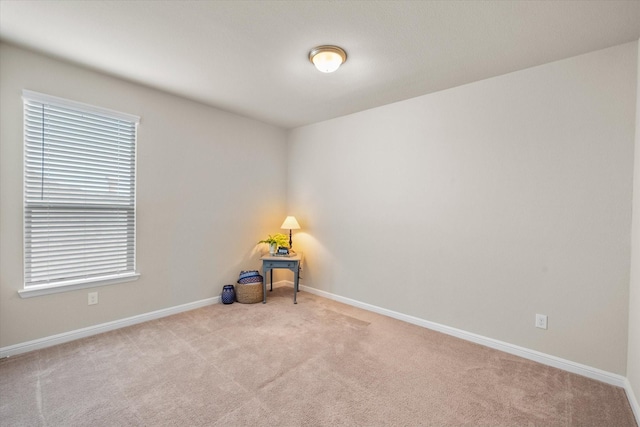 carpeted spare room with baseboards