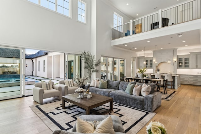 living room featuring light hardwood / wood-style floors and ornamental molding