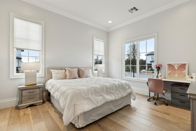 bedroom with crown molding and light hardwood / wood-style flooring