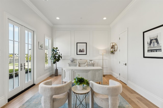 living area featuring light wood-type flooring, french doors, and crown molding