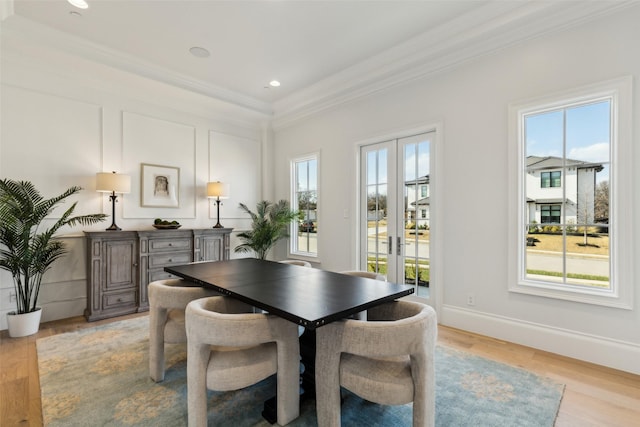 dining area with french doors, light hardwood / wood-style floors, crown molding, and plenty of natural light