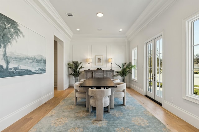 office space with ornamental molding, french doors, and light hardwood / wood-style flooring