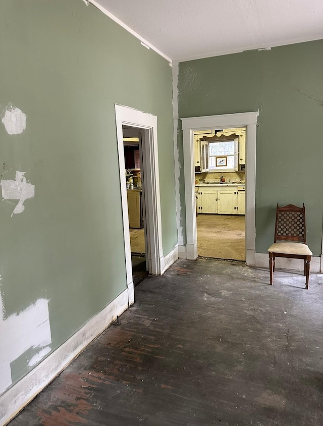 hallway with crown molding and dark wood-type flooring