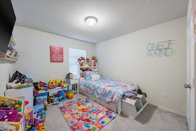 bedroom featuring carpet floors and a textured ceiling