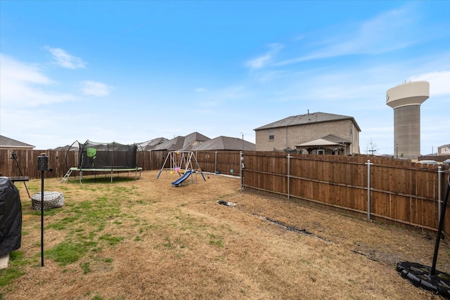 view of yard featuring a playground and a trampoline