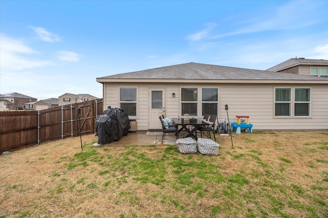 back of house featuring a patio and a yard