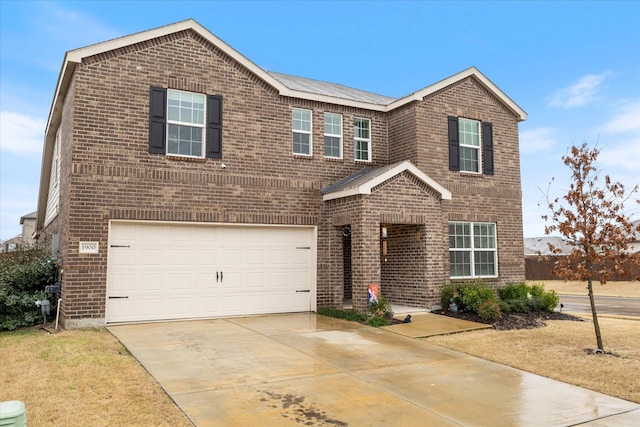 view of front of property featuring a front yard and a garage