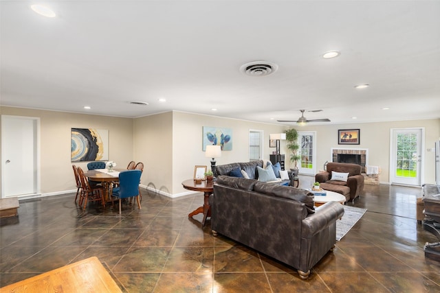 living room featuring a brick fireplace, crown molding, and ceiling fan