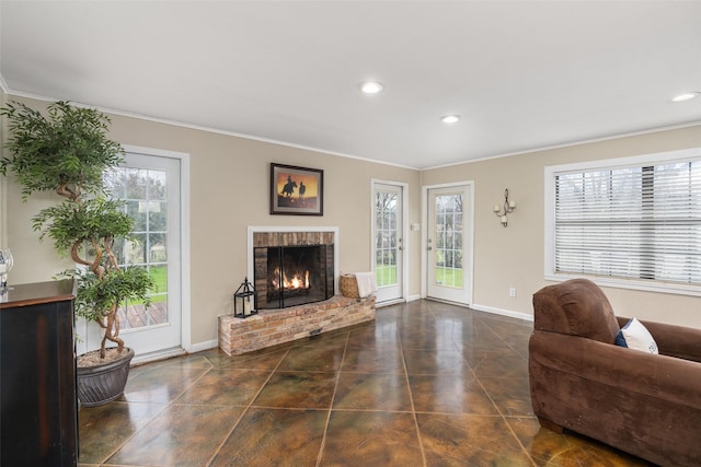 living room with dark tile patterned flooring, ornamental molding, and a fireplace