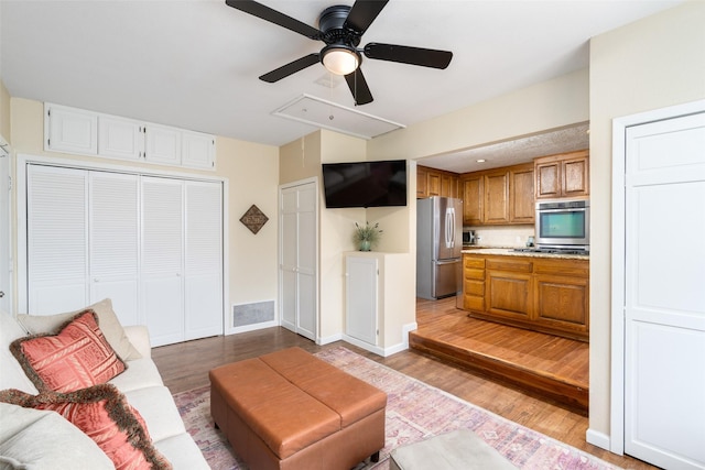 living room featuring light wood-type flooring and ceiling fan