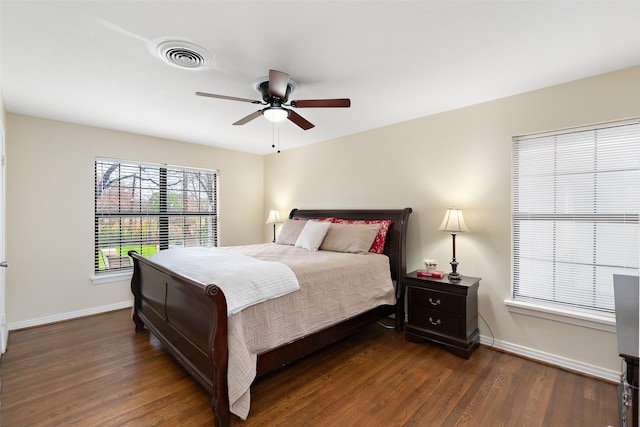 bedroom with dark hardwood / wood-style floors and ceiling fan