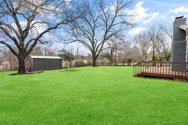 view of yard with a shed and a wooden deck