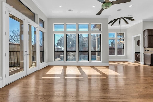 doorway to outside featuring light wood-style floors, visible vents, and crown molding