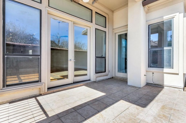 property entrance with a patio and stucco siding