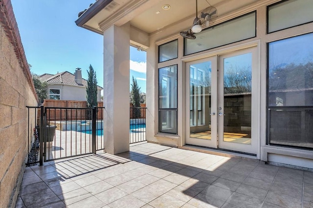 exterior space featuring a patio area, a ceiling fan, and french doors