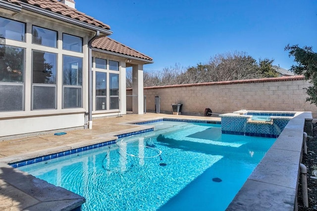 view of swimming pool with fence, a fenced in pool, and an in ground hot tub