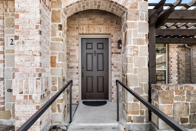 doorway to property featuring stone siding