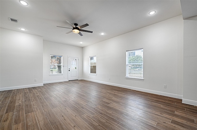 empty room with dark hardwood / wood-style floors and ceiling fan