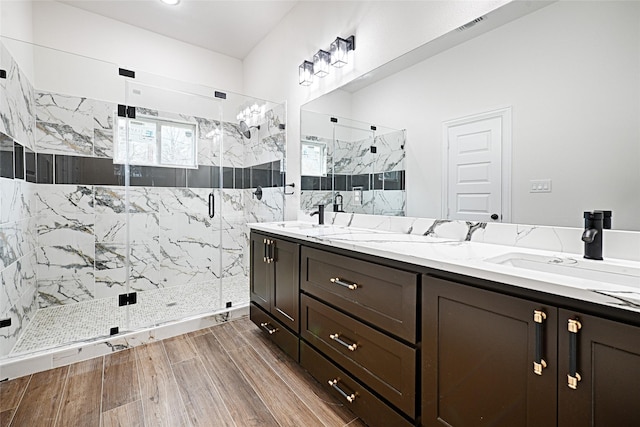 bathroom with vanity and a shower with door