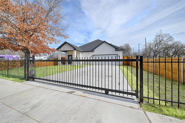 view of gate with a garage and a yard