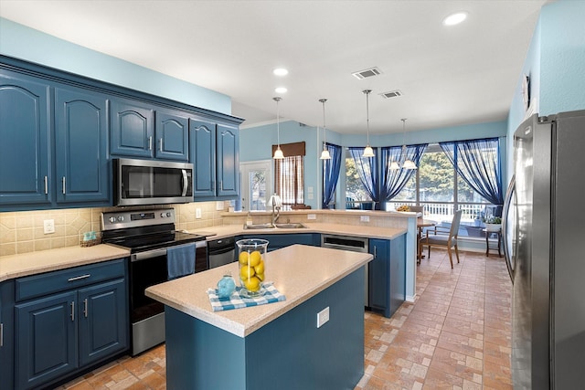 kitchen with blue cabinets, stainless steel appliances, and a center island