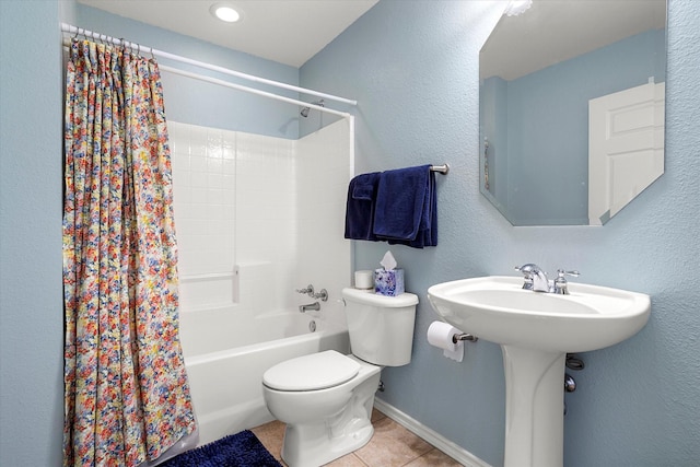 bathroom featuring tile patterned flooring, shower / tub combo with curtain, and toilet