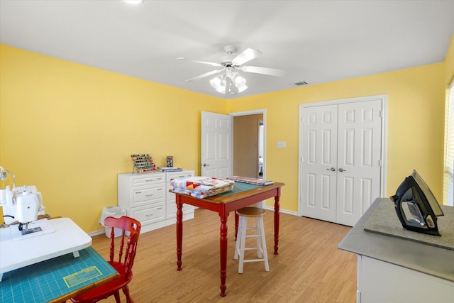 home office featuring ceiling fan and light hardwood / wood-style floors