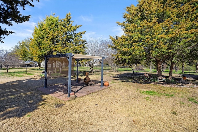 view of play area featuring a pergola and a lawn