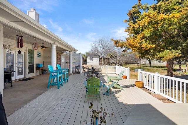 deck featuring ceiling fan and a grill