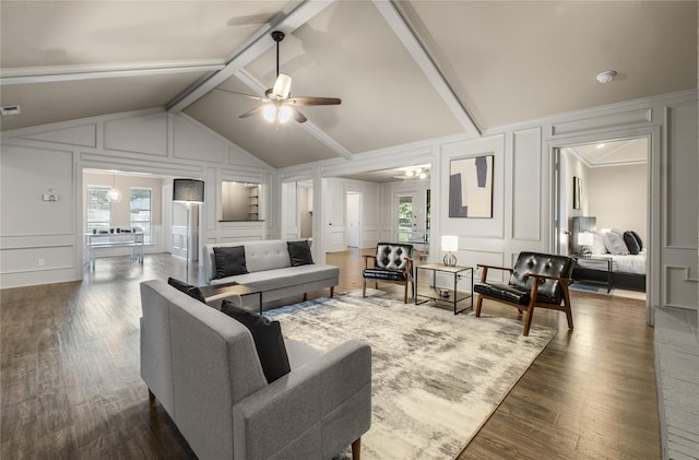 living room with vaulted ceiling with beams, dark hardwood / wood-style floors, and ceiling fan