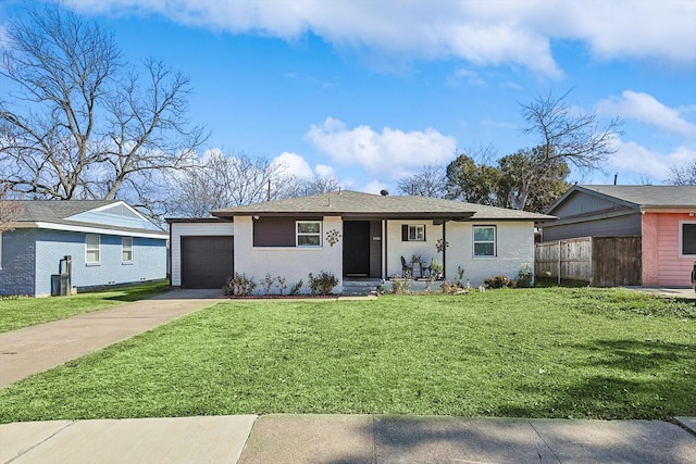 single story home with a garage and a front lawn