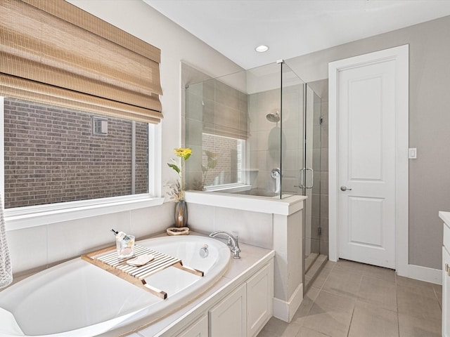 bathroom featuring a stall shower, baseboards, tile patterned floors, a bath, and recessed lighting