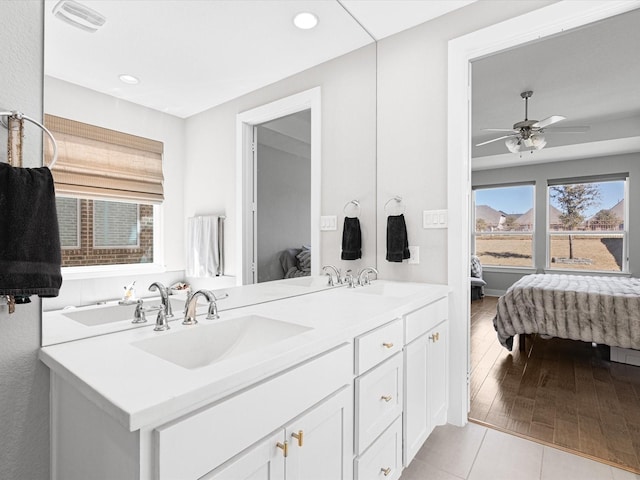 ensuite bathroom with visible vents, a sink, ensuite bath, and double vanity