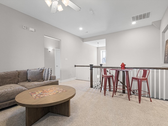 living area with recessed lighting, visible vents, a ceiling fan, light carpet, and baseboards