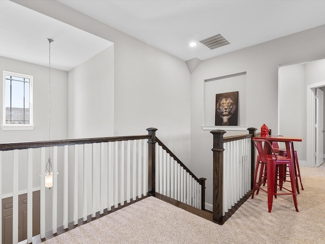 hall featuring carpet flooring, an upstairs landing, visible vents, and recessed lighting