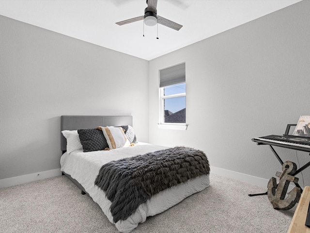 carpeted bedroom with ceiling fan and baseboards