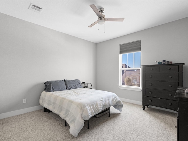 bedroom with visible vents, ceiling fan, light carpet, and baseboards